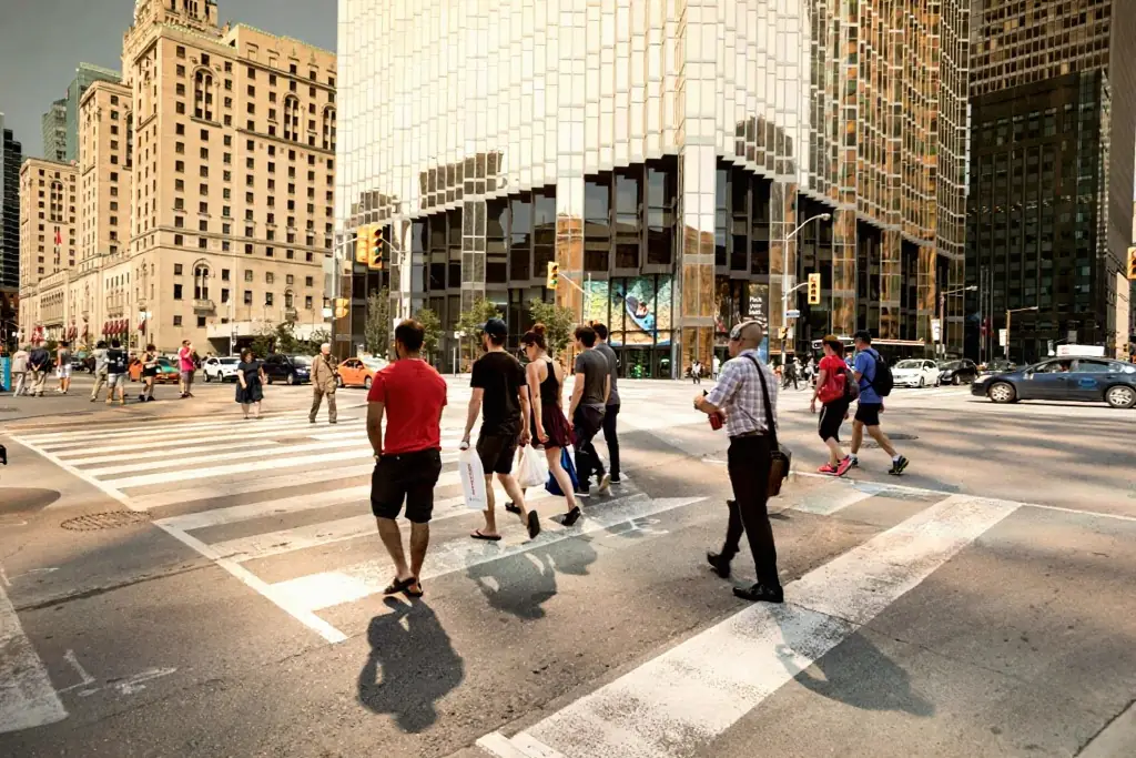 People crossing a downtown Toronto intersection on foot
