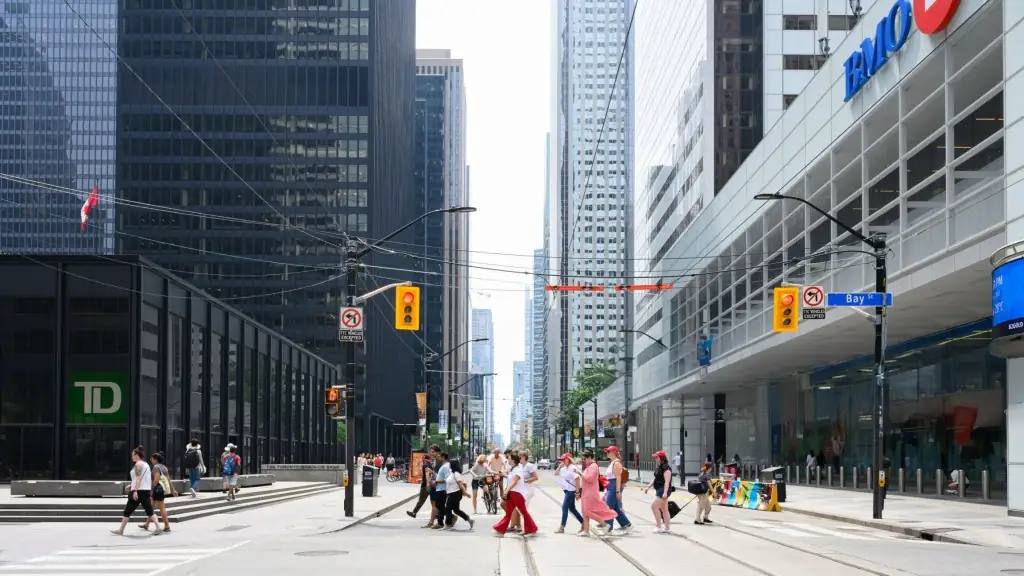 People crossing Bay Street in downtown Toronto