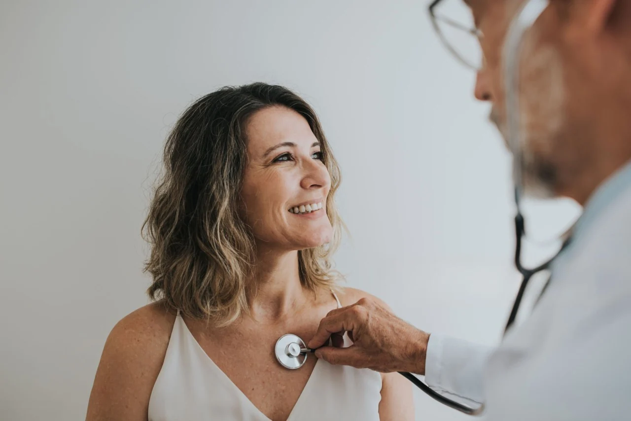 Doctor reviewing health records with patient during annual checkup