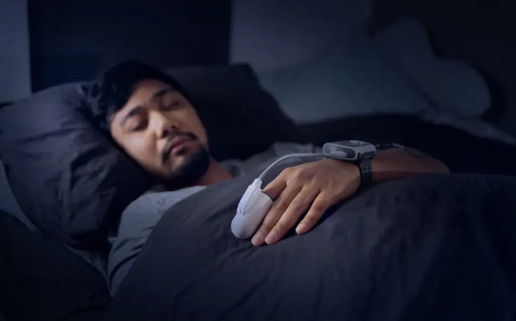 Man undergoing sleep study with monitoring equipment in Toronto sleep clinic